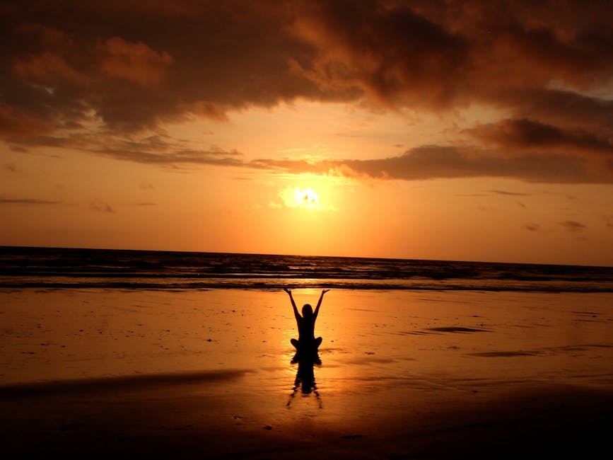 pexels-photo-268134-268134-1 Peaceful meditation silhouette at sunset on a serene beach.